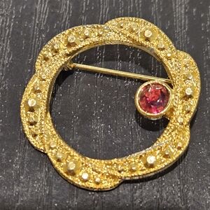 Gold Tone Circle Brooch with Red Rhinestone Accent